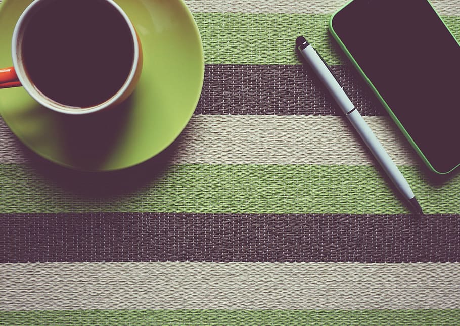 flat-lay photography of teacup beside iPhone and pen on striped table, HD wallpaper