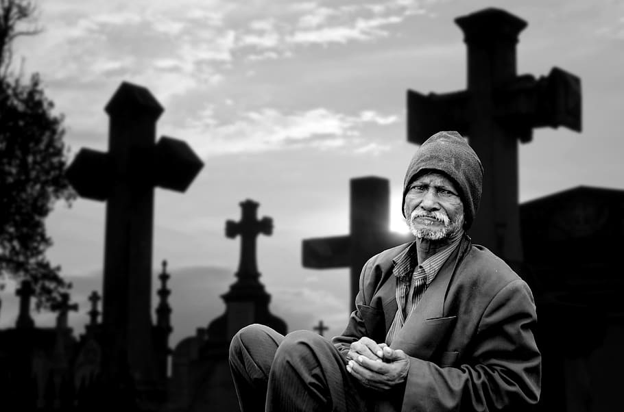 grayscale photo of a man sitting near black cross, human, mourning HD wallpaper