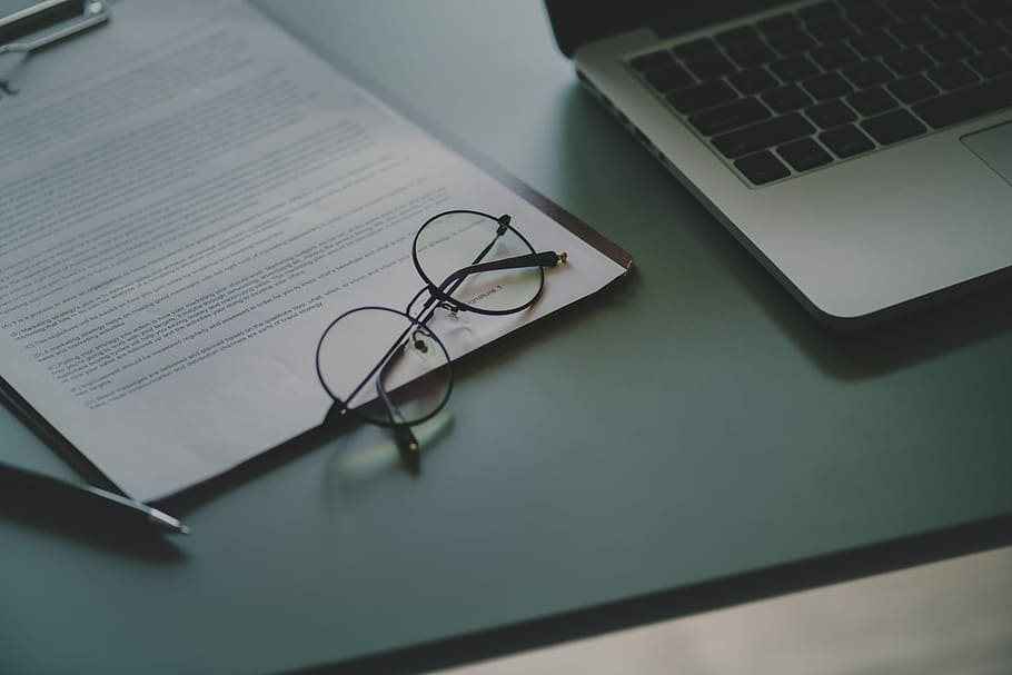 eyeglasses with black frames beside laptop computer, table HD wallpaper