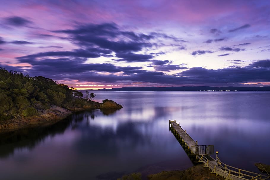 landscape photography of mountains and body of water, landscape photography of brown sea dock near mountain HD wallpaper
