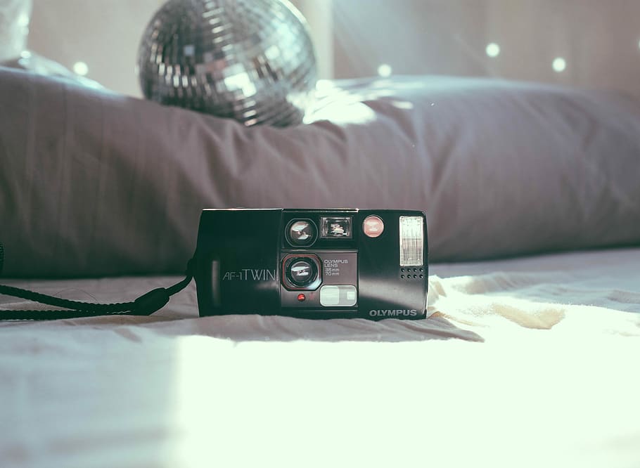 black Olympus film camera near mirror ball on bed, disco ball HD wallpaper