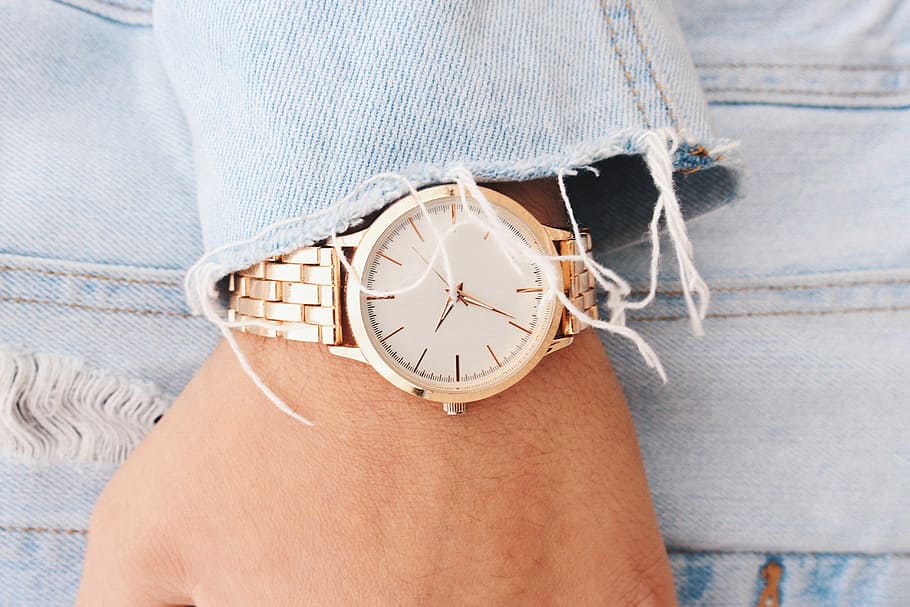 analog watch pointing at 9:45, person wearing gold-colored analog watch HD wallpaper