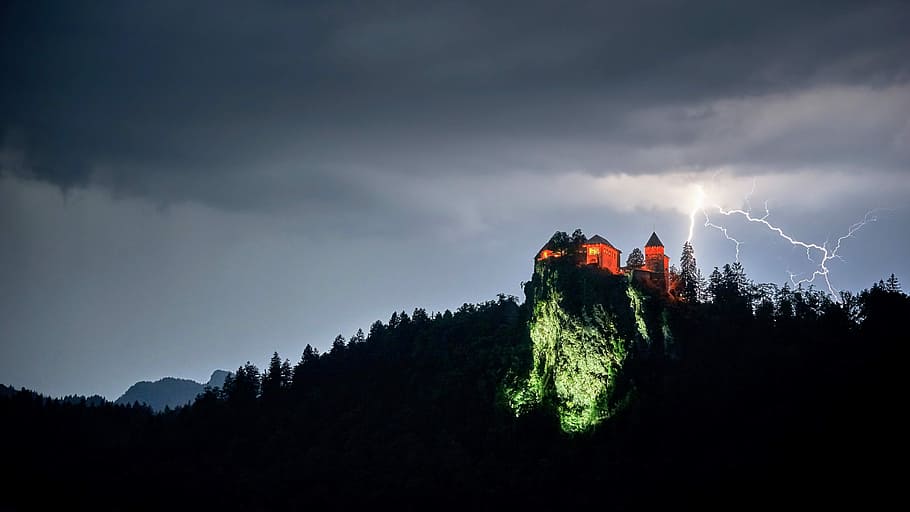 orange and gray castle on top on mountain, lightning, building HD wallpaper