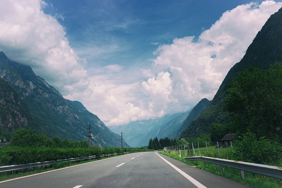 Road through a mountain village, photo of a road between mountains HD wallpaper