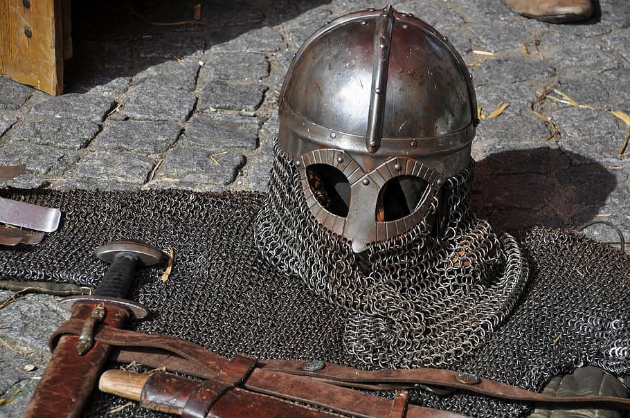 gray chain mail helmet and armor on gray brick floor, knight