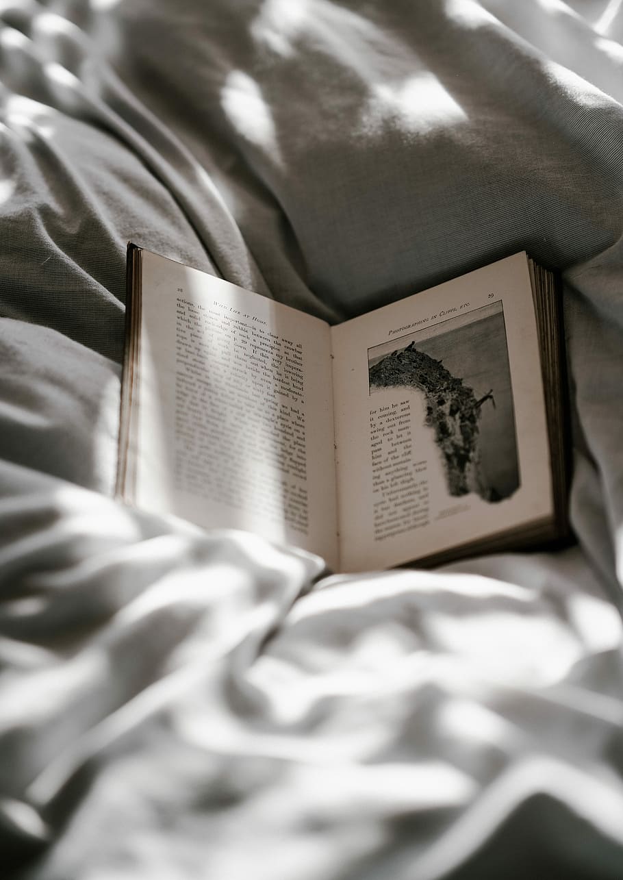 opened-book on top of bed sheet, opened book on top of blanket HD wallpaper