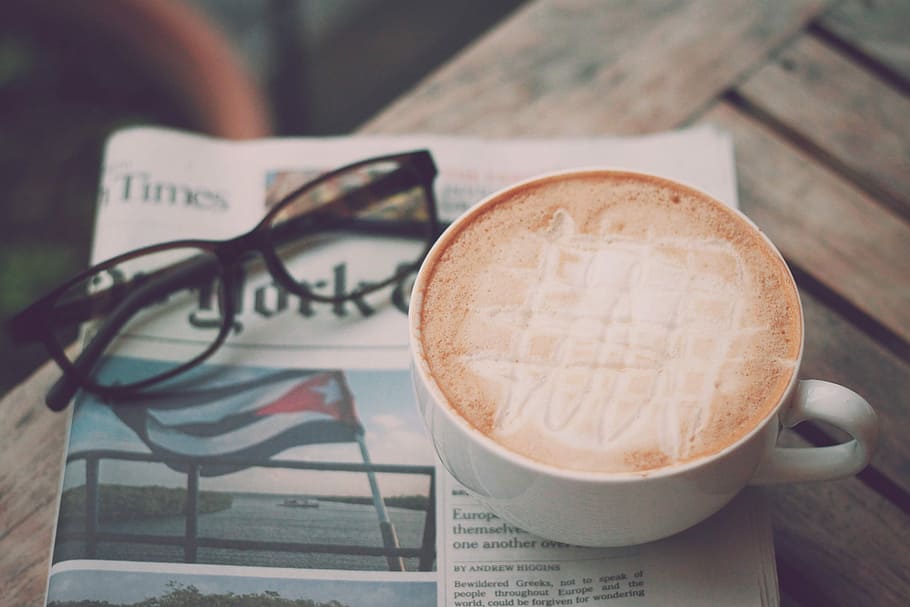 white coffee cup on top of newspaper near on black framed eyeglasses HD wallpaper
