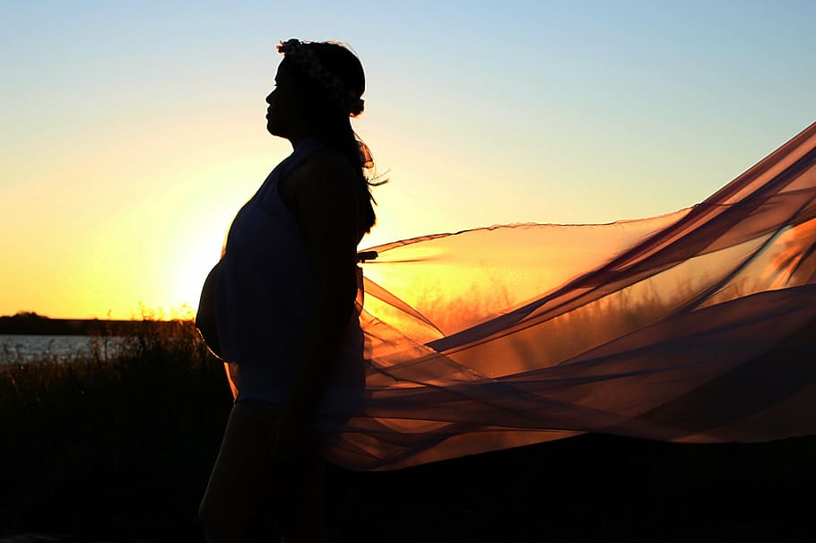 silhouette photography of woman during sunset, pregnant woman
