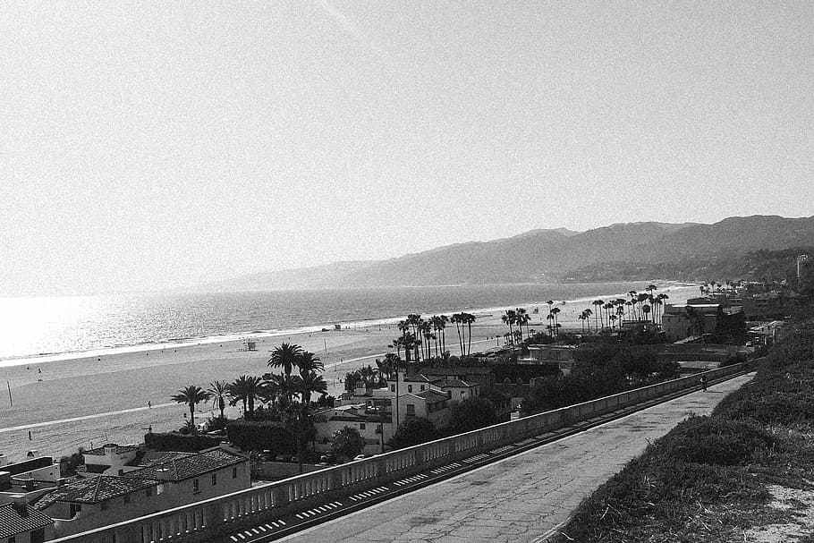 grayscale photography of beach, buildings, near, body, water HD wallpaper