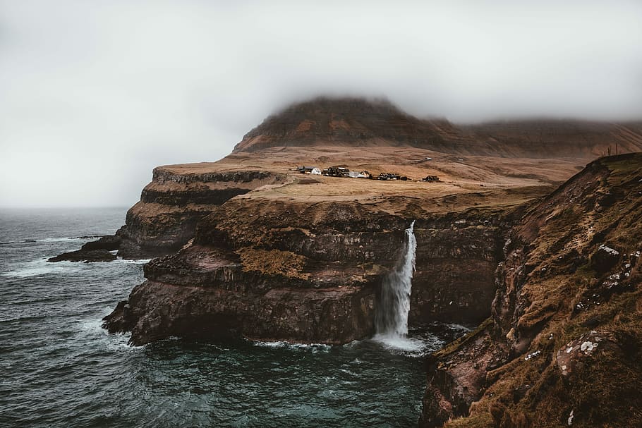 waterfalls rushing in to the water, close-up photo of waterfalls under white clouds HD wallpaper