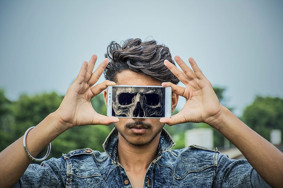 person holding a white Android smartphone, skull, man, halloween HD wallpaper