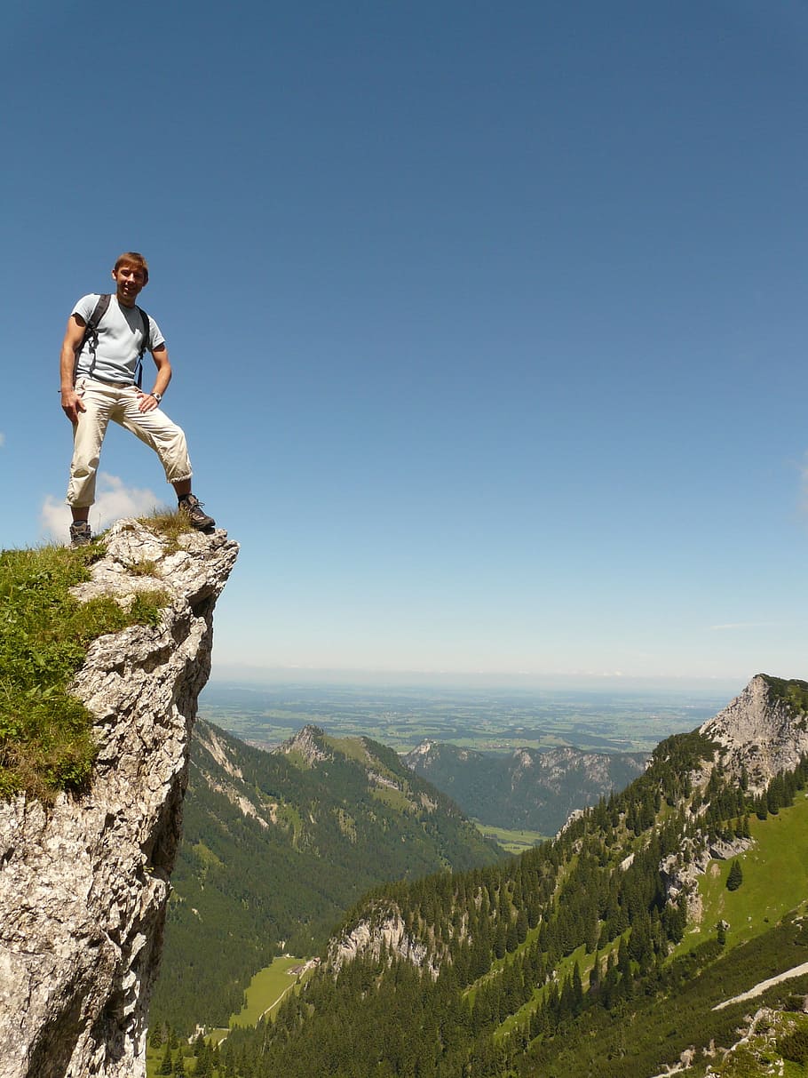 man standing on edge of the cliff, mountain, hiking, hike, exposed
