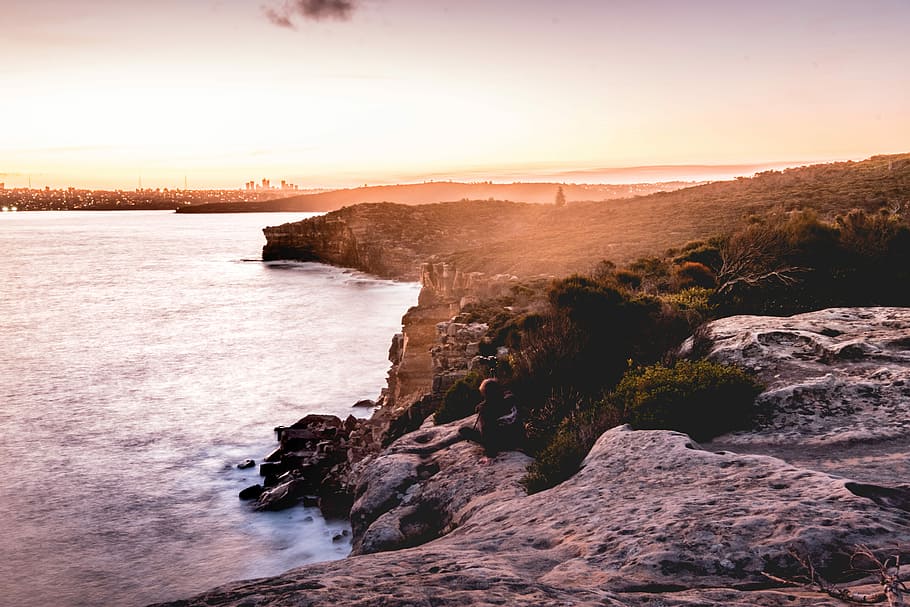 rock formation near body of water during golden hour, rocks cliffs near ocean HD wallpaper