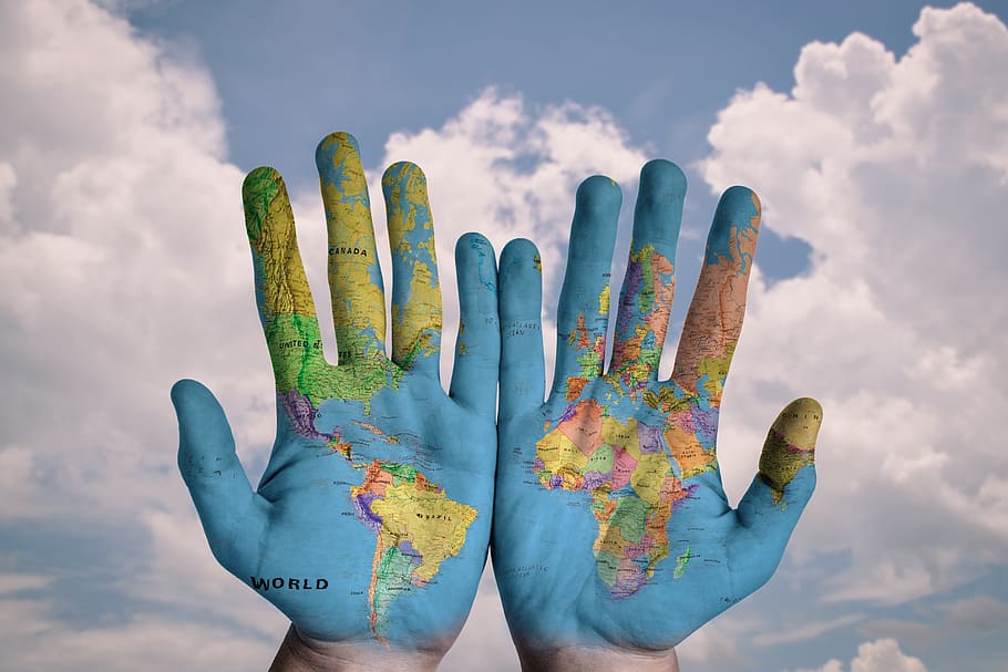world map hand paint, photography of two hands with map painting, HD wallpaper
