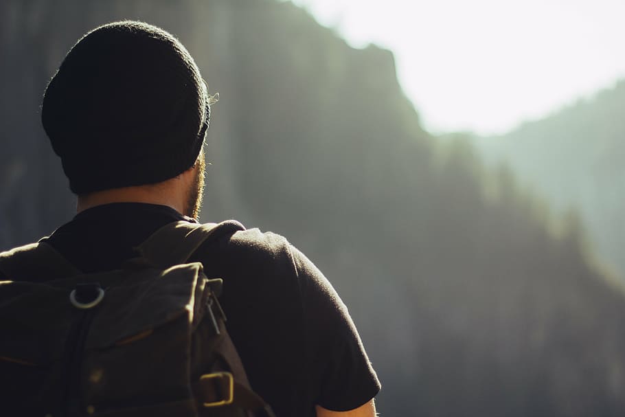 man in black t-shirt, black beanie, and brown backpack, hiking HD wallpaper