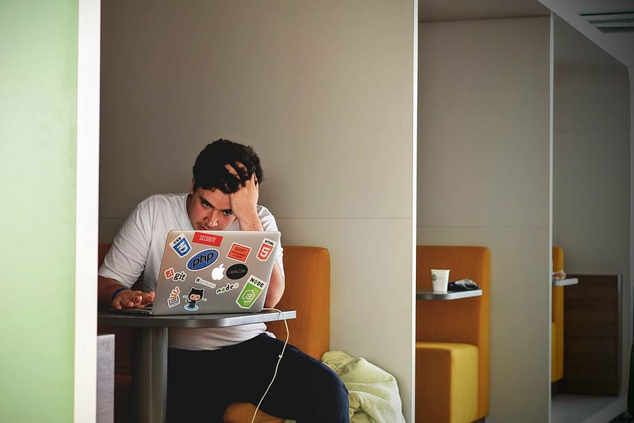 man sitting in front of table while using silver MacBook, people HD wallpaper