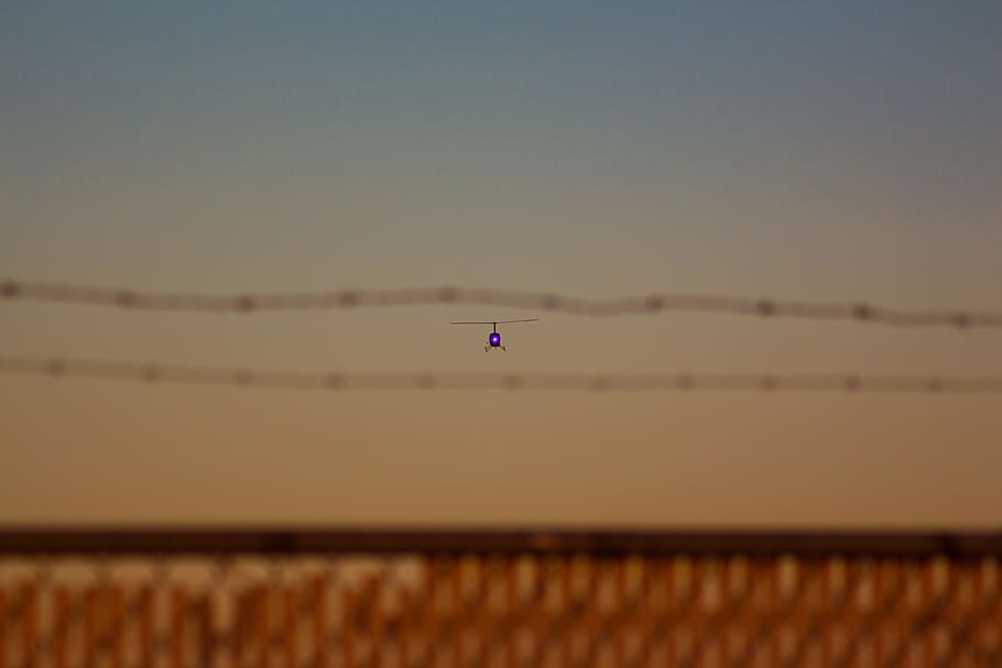 focus photography of helicopter flying, sight, flight, barbed wire HD wallpaper