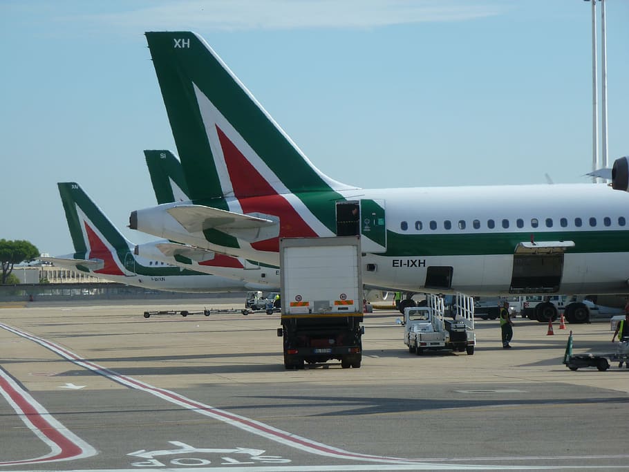 white-red-and-green airliner on gray concrete ground, airplane