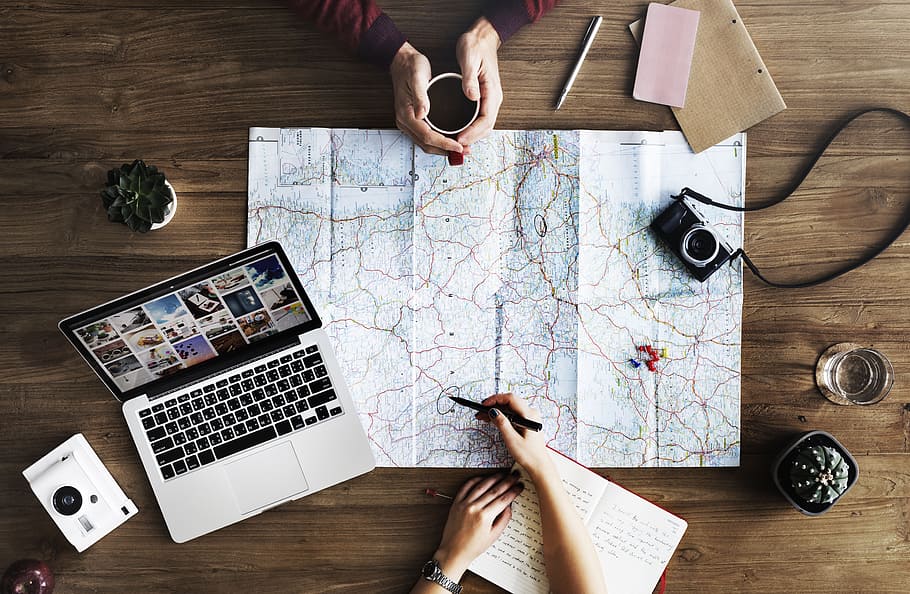 person holding black pen pointing at white and brown map, laptop HD wallpaper