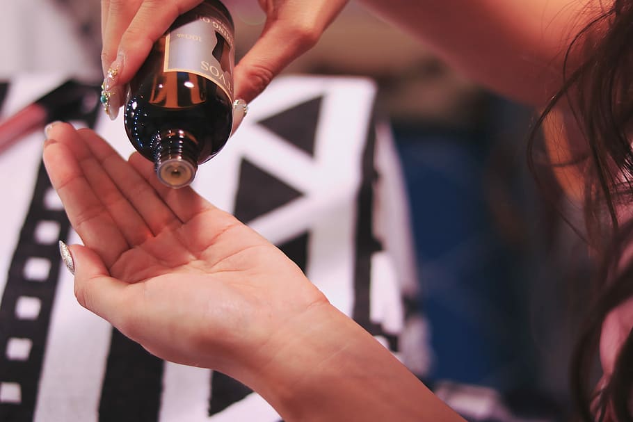 person pouring liquid from black bottle, human Hand, women, people HD wallpaper