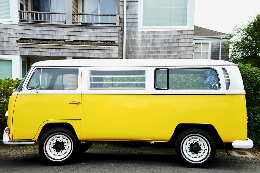 yellow and white Volkswagen Kombi, yellow and white Volkswagen Type 2 van parked in front of gray house