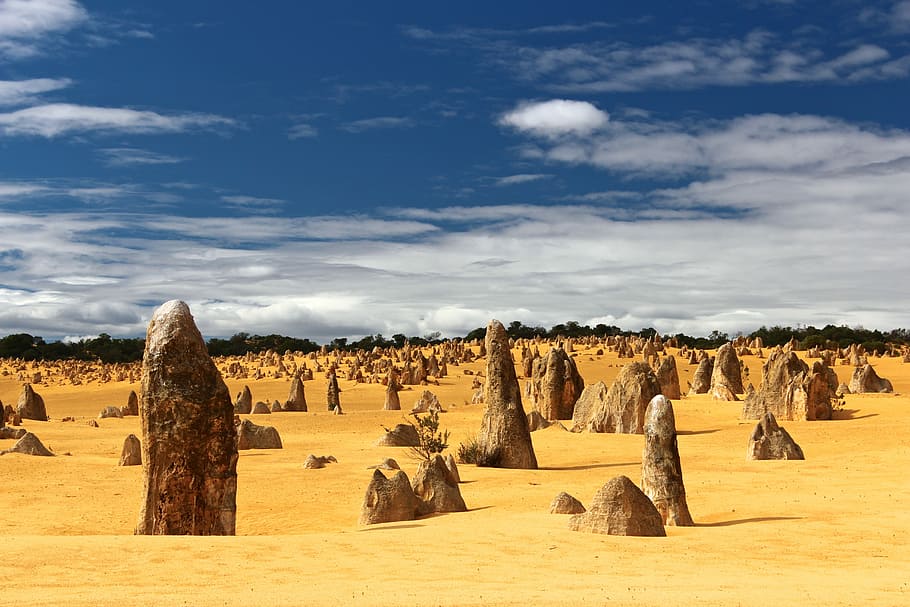 field of rocks, landscape photography of desert under blue sky and white clouds during daytime HD wallpaper