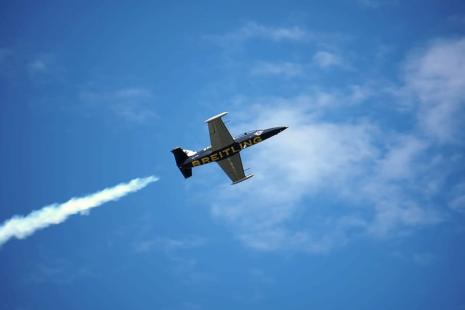 Breitling Aerial Show in Geneva, gray and black Breitling plane under blue and white sky at daytime HD wallpaper