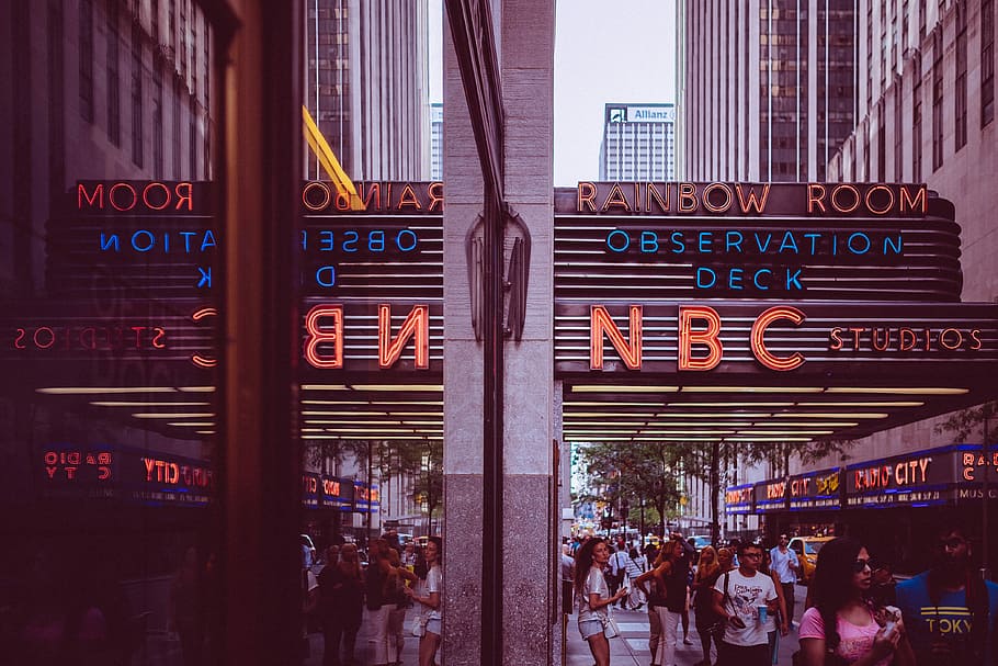 group of person walking near city buildings, people walks under NBC signage during daytime, HD wallpaper