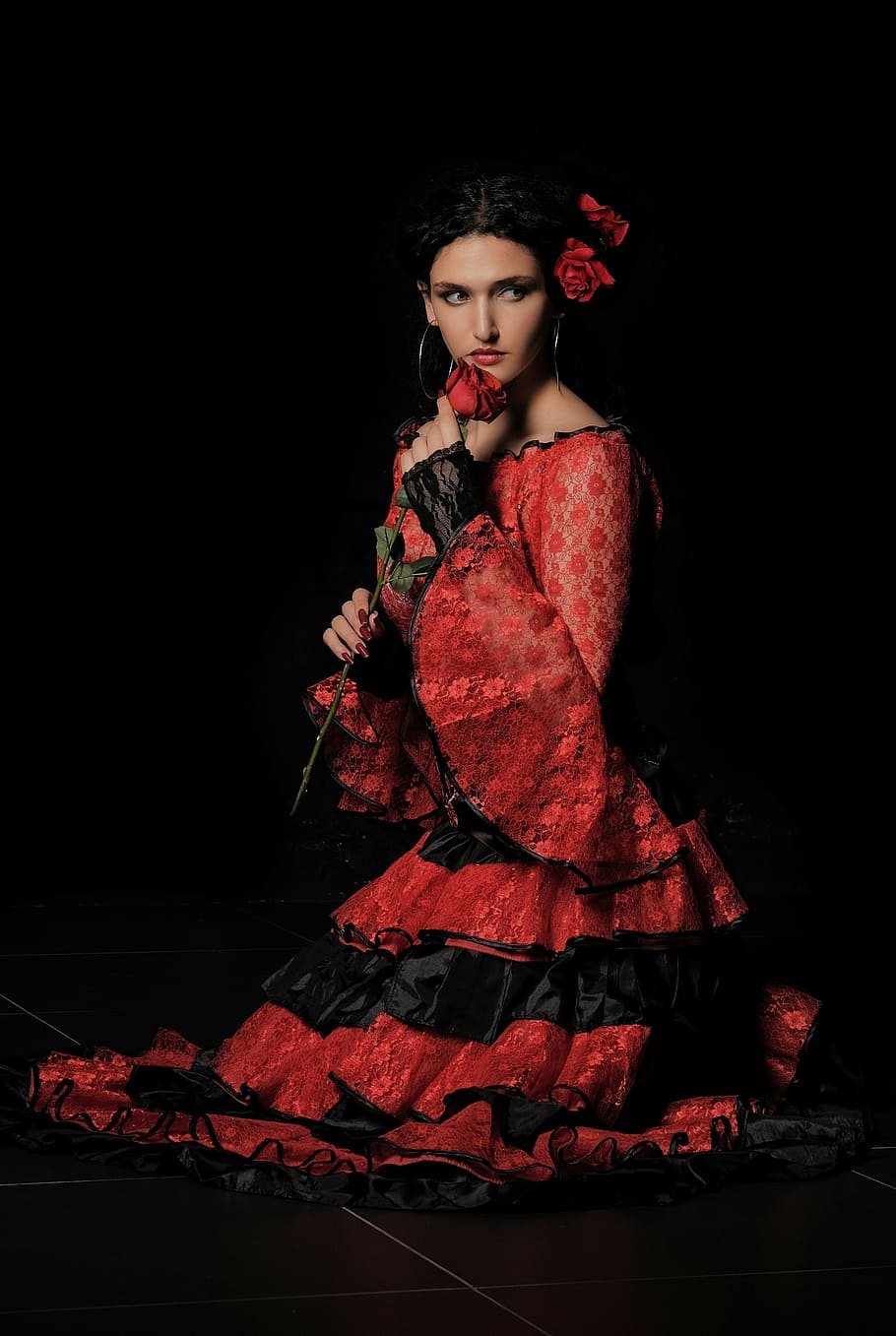 woman wearing red and black long-sleeved ruffled dress holding rose on black background, HD wallpaper