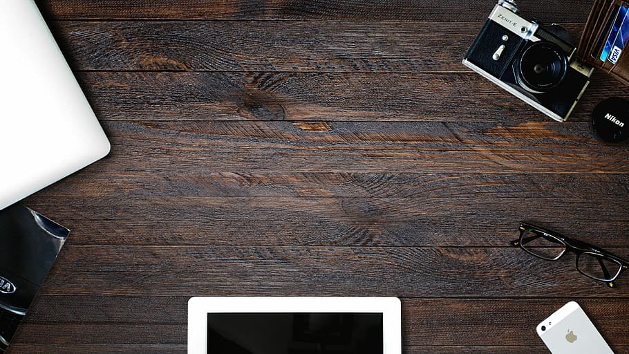 black camera with black eyeglassse, black and silver point-and-shoot camera on brown wooden surface HD wallpaper