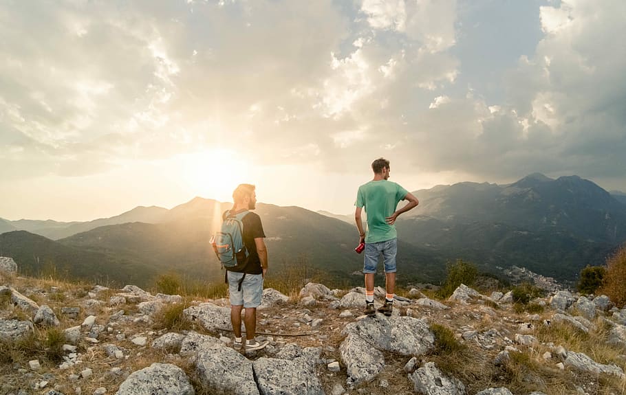 two men standing on top of the mountain, two men standing on rocks during daytime, HD wallpaper