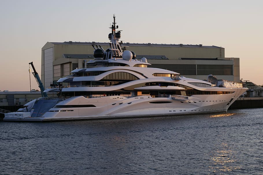 white crew ship beside dock at daytime, luxury yacht, yacht building