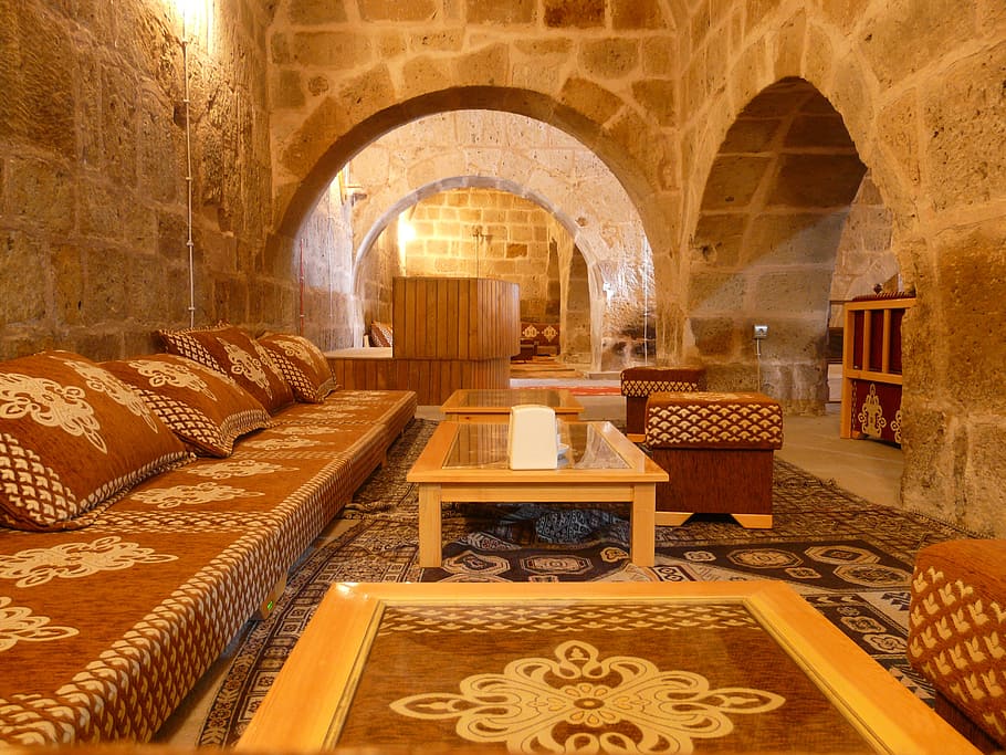 brown wooden center table and brown couch inside a room, caravanserai