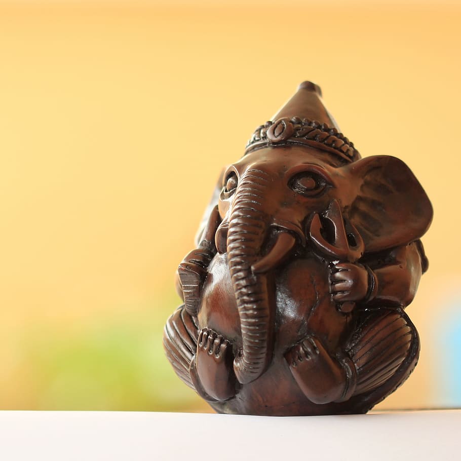 brown wooden elephant figurine on white surface, ganesh, ganesha