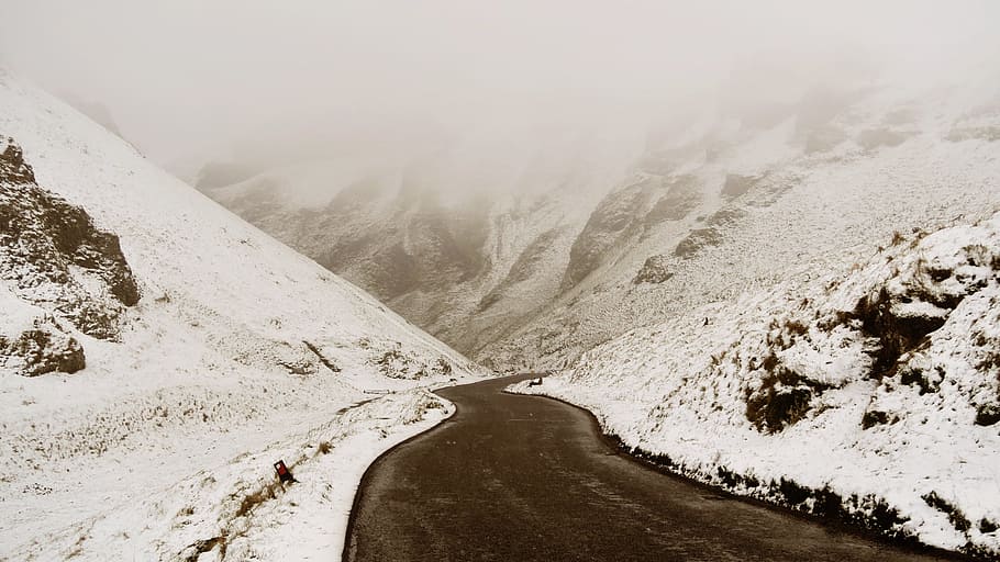 asphalt road surrounded by snow-covered field during daytime, road between snow covered field HD wallpaper
