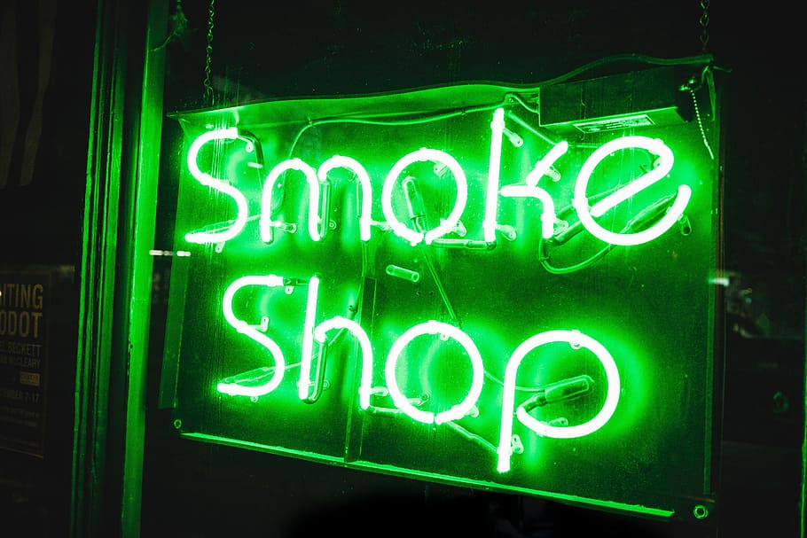 turned on smoke shop NEON signage, green lighted smoke shop neon light signage