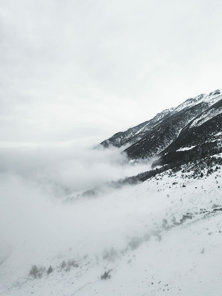 snow capped mountain under cloudy sky at daytime, aerial view photography of snow mountain HD wallpaper