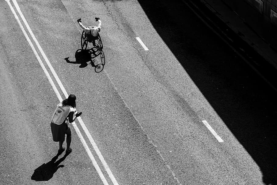 person standing on the road grayscale photography, person riding wheelchair on road, HD wallpaper