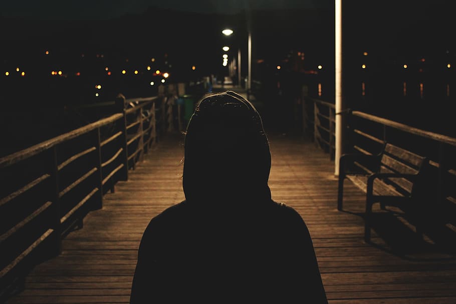 person wearing hooded jacket walking in bridge, person standing on brown wooden pathway, HD wallpaper