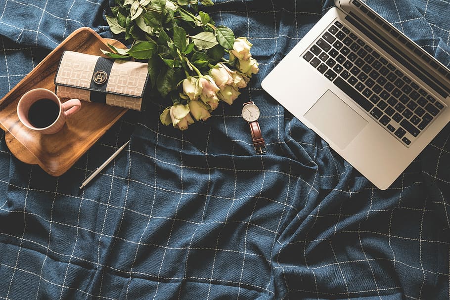 flat lay photography of MacBook Pro, wallet, watch, coffee, tray, and bouquet of flower, MacBook Pro beside the petaled flower and analog watch HD wallpaper