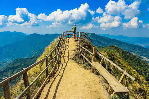 Photo of a Man Standing in the Cliff, background, bench, clouds HD wallpaper