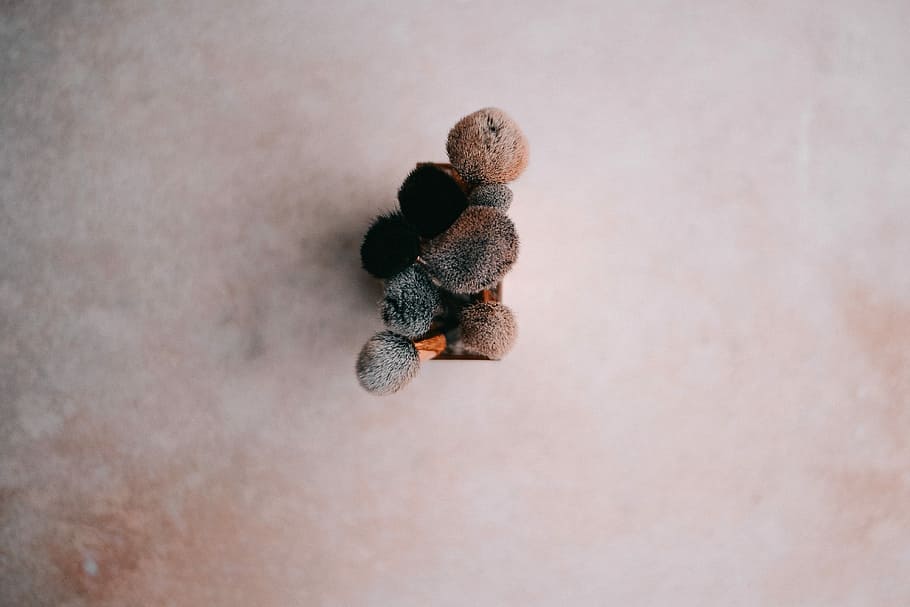 Make up brushes, brown stones on beige cloth, decor, flatlay HD wallpaper