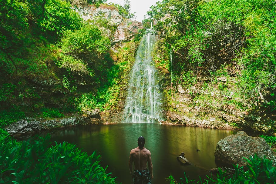 man standing in front of waterfalls during daytime, person HD wallpaper