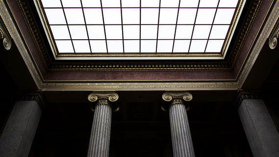 low angled vie of brown and brass columns ceiling structures HD wallpaper