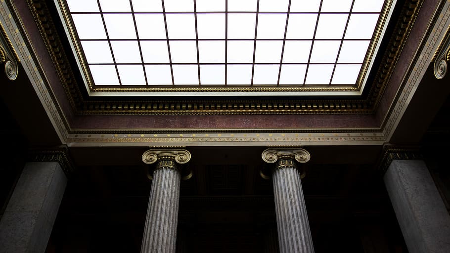 low angled vie of brown and brass columns ceiling structures HD wallpaper