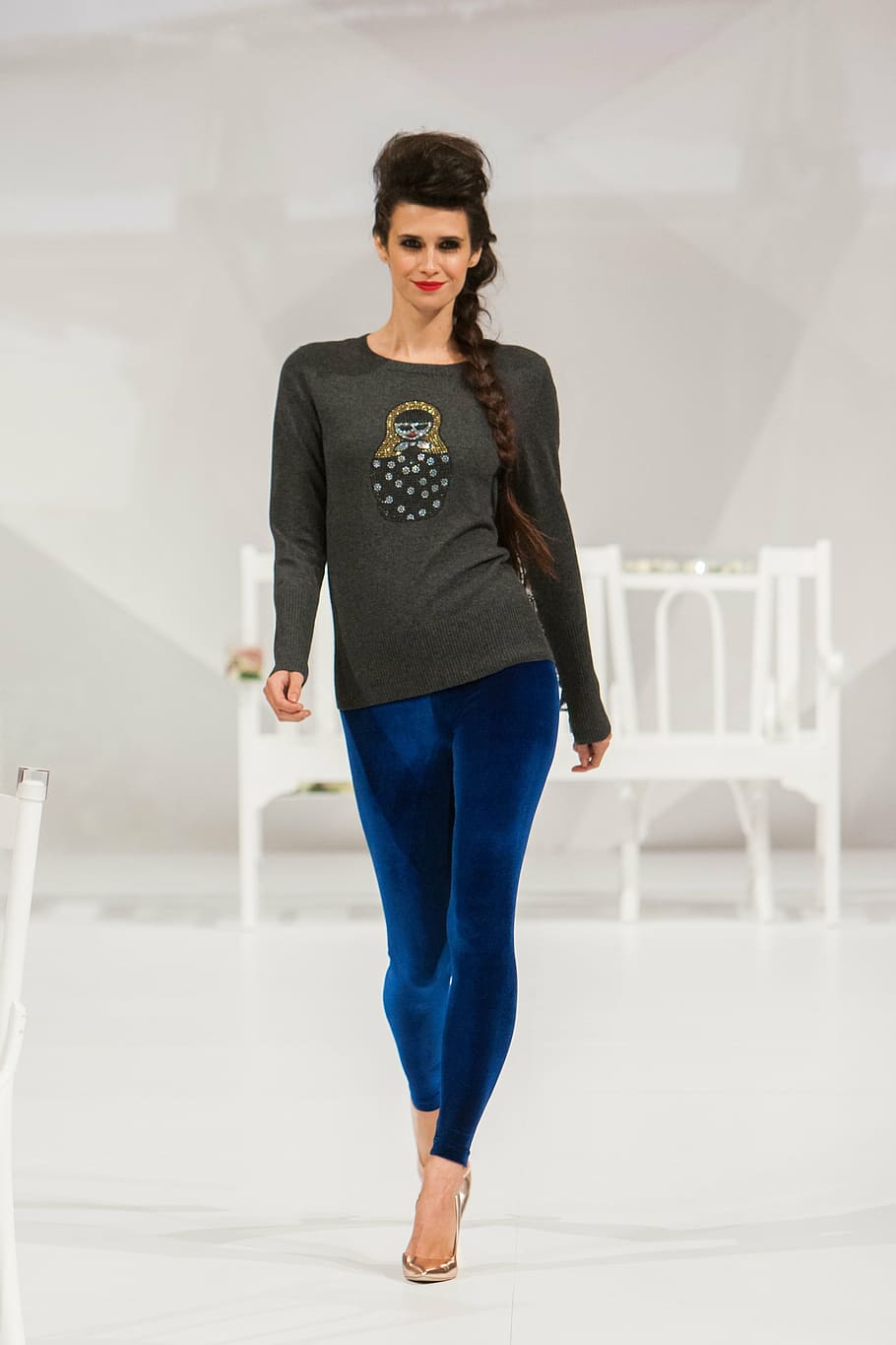 women's gray long-sleeved shirt and blue pants indoor, fashion show
