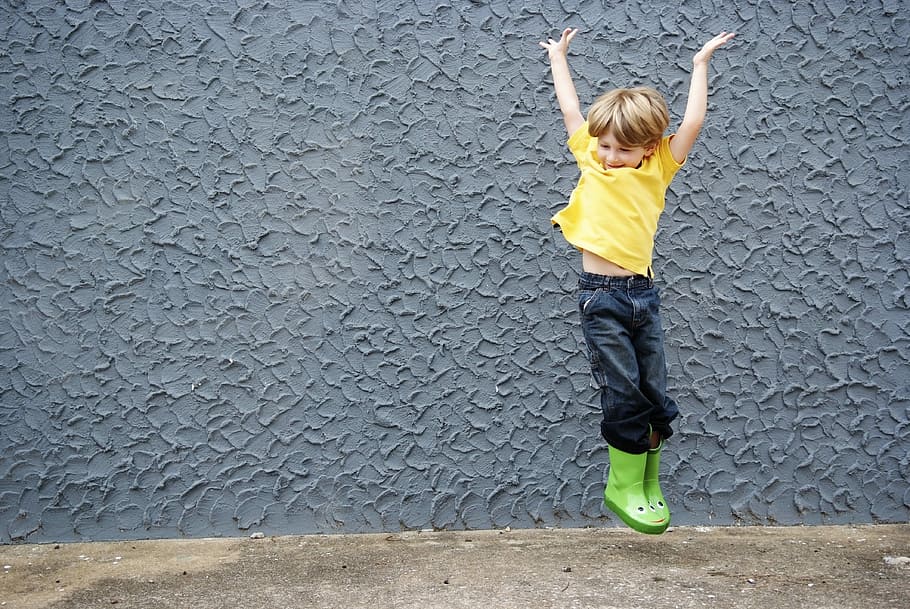 boy jumping beside grey wall, happy boy, child, children, fun, HD wallpaper