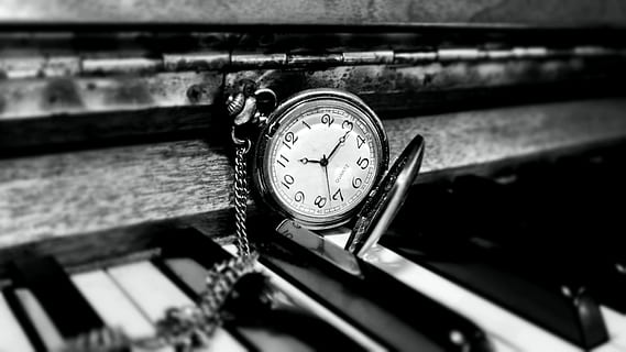 round white and silver-colored pocket watch on top of piano HD wallpaper