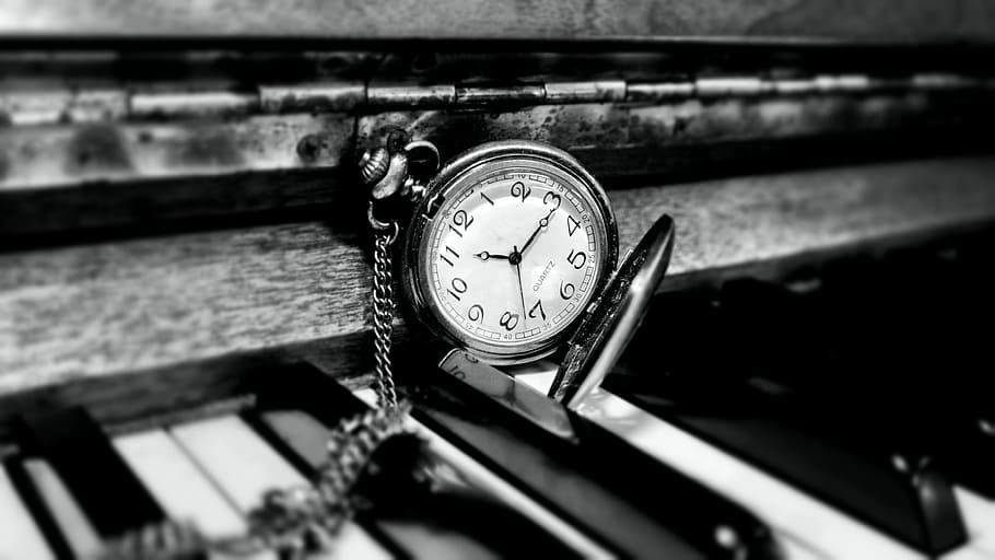round white and silver-colored pocket watch on top of piano HD wallpaper