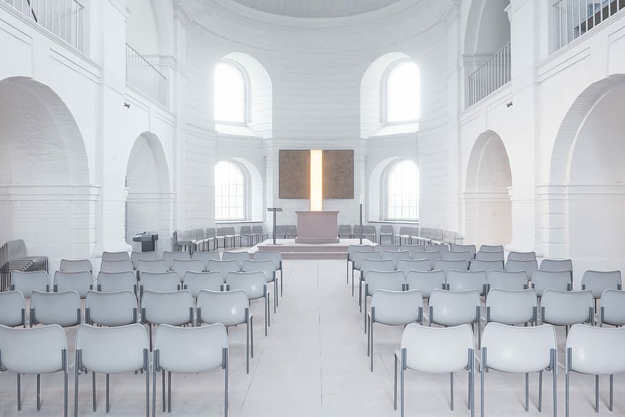 photography of white chairs in white concrete chapel, church